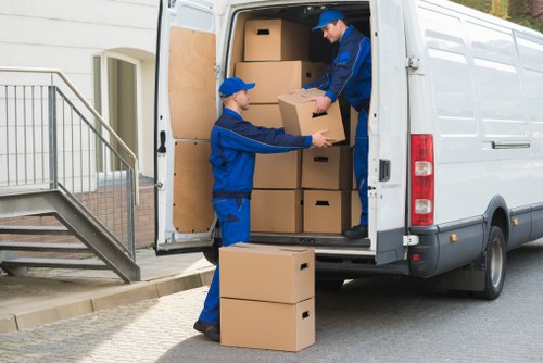 Removal team preparing items with safety equipment during a house move