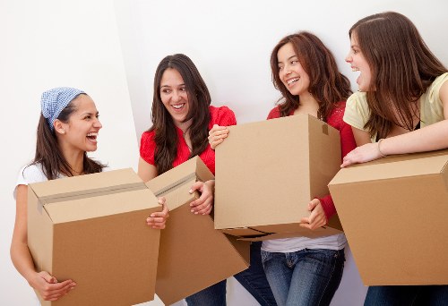 Professional movers loading items into a removal van