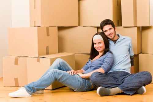 Professional movers loading household items into a moving van in West London