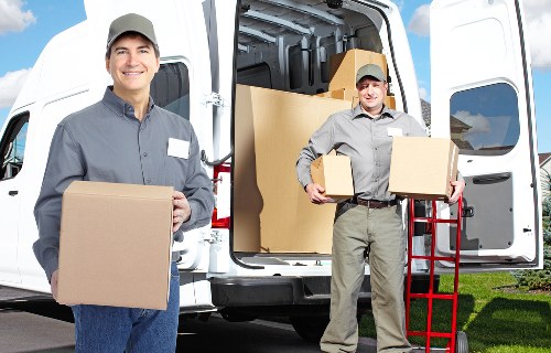 Packed moving boxes and furniture ready for transport in West London