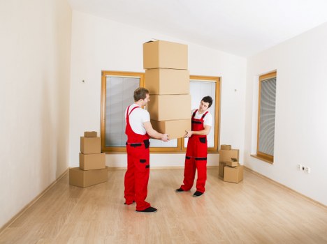 Trained movers carrying furniture carefully through a property